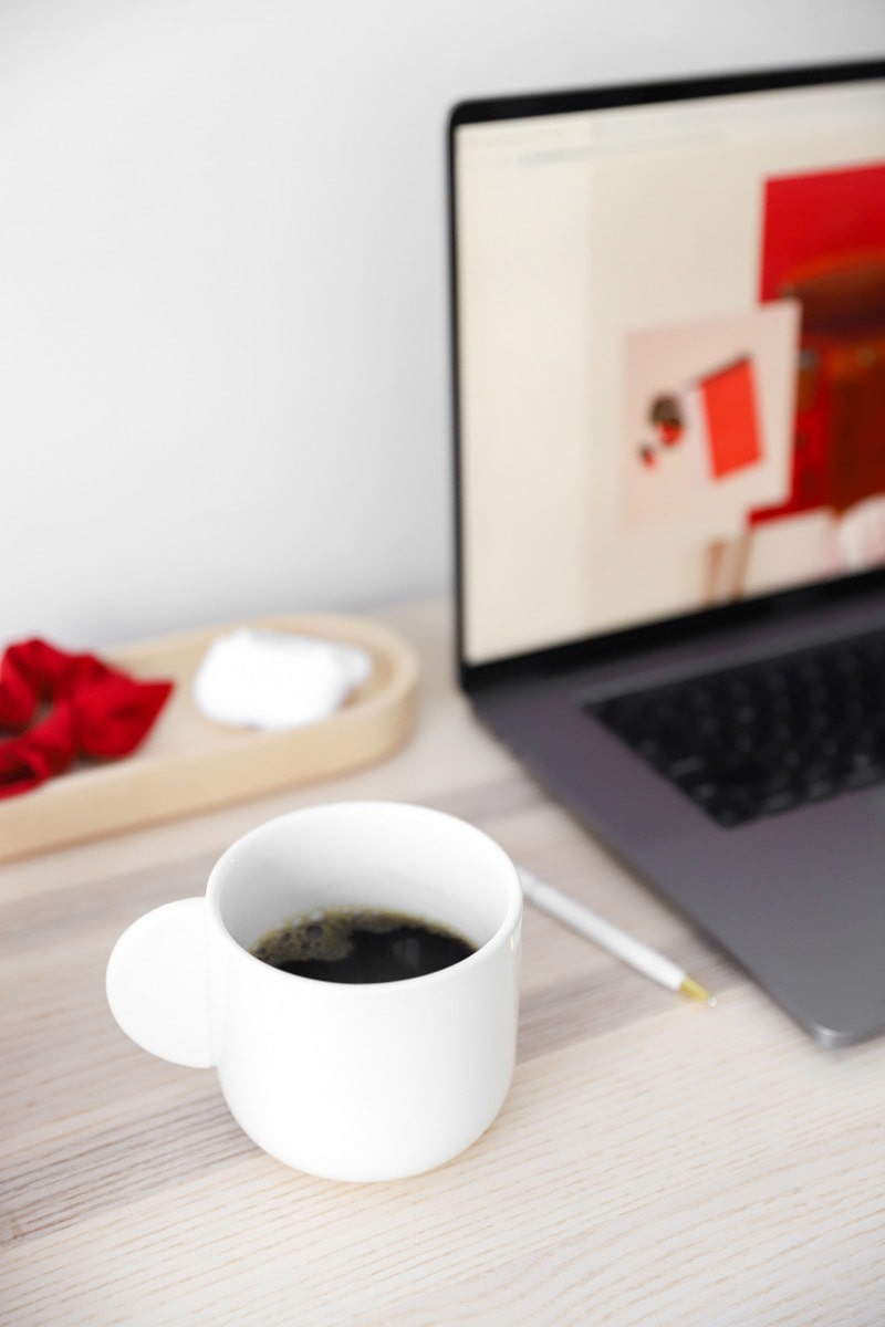 cup of coffee and laptop on a desk